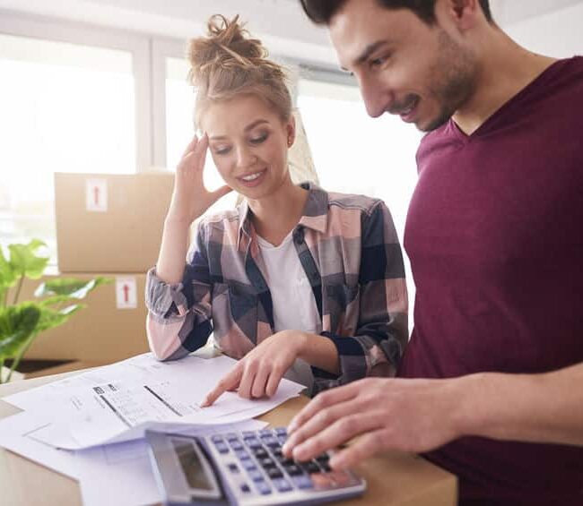Worried couple examining expenses after moving into new house demenager pas cher
